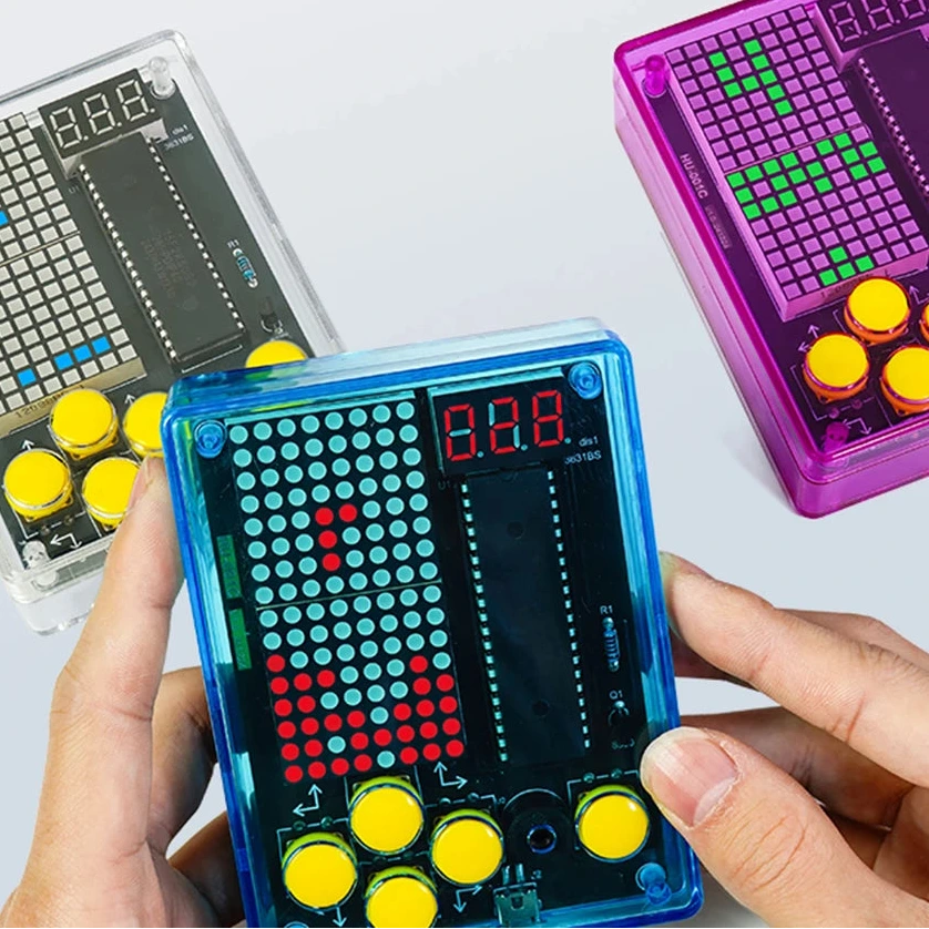 Hand holding a pixel game device with other similar devices in the background, featuring text about classic and innovative games.