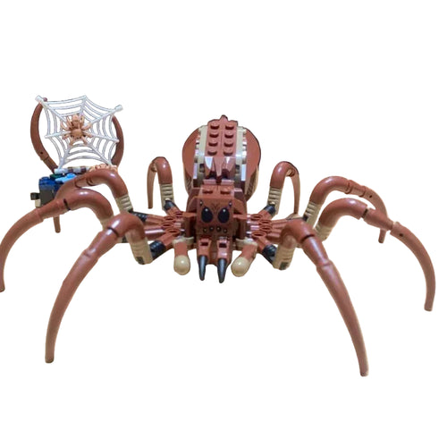 Toy spider made of interlocking bricks on a wooden surface